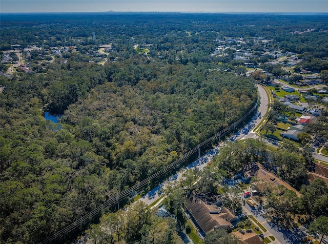bird's eye view with a wooded view