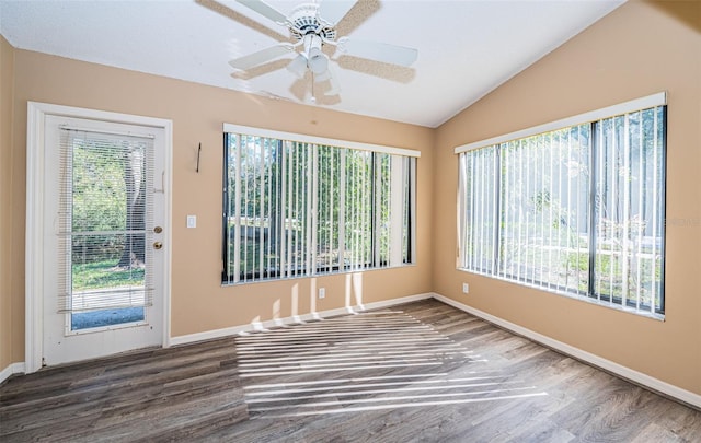 spare room with dark hardwood / wood-style floors, ceiling fan, and vaulted ceiling