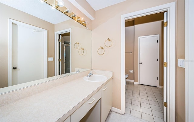 bathroom with vanity, toilet, and tile patterned floors