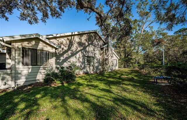 view of property exterior with a yard