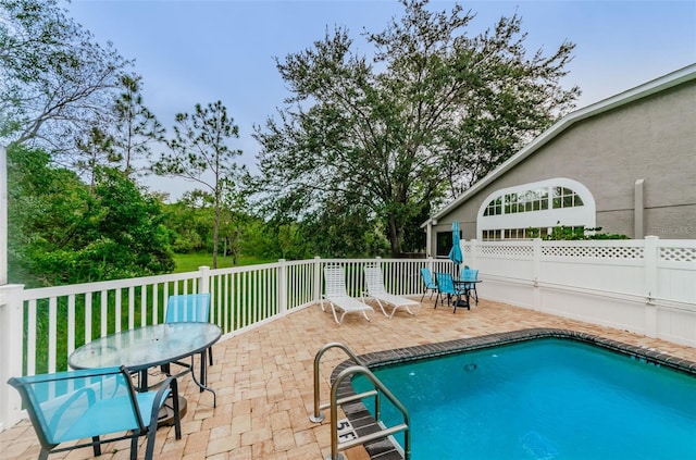 view of swimming pool with a patio area