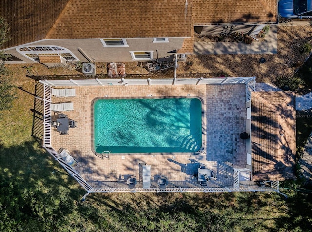 view of swimming pool with a patio and a lawn