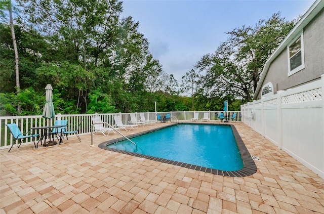 pool with fence and a patio area