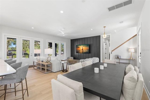 dining space with light hardwood / wood-style floors and ceiling fan