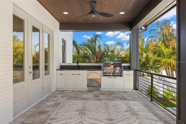 view of patio / terrace featuring area for grilling, grilling area, a balcony, sink, and ceiling fan