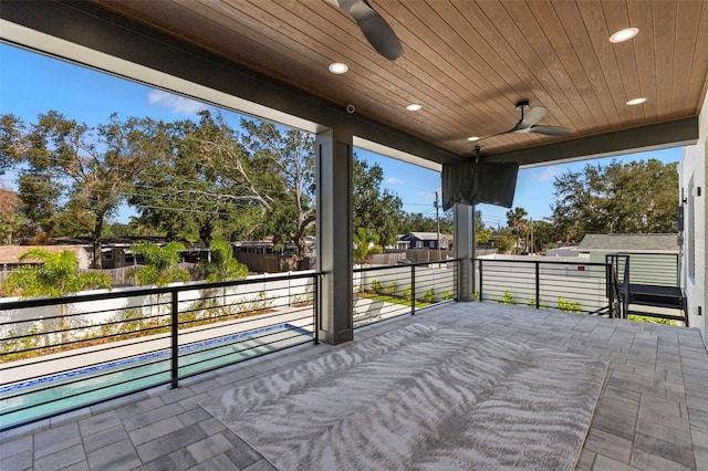 view of patio / terrace with a balcony, a pool, and ceiling fan