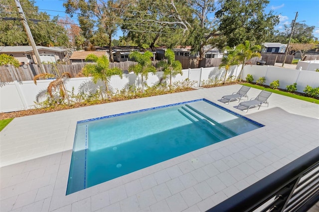 view of swimming pool featuring a patio area