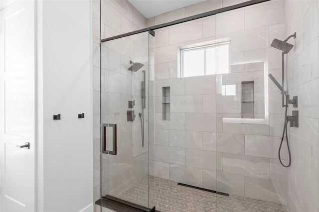 bathroom featuring a shower with door