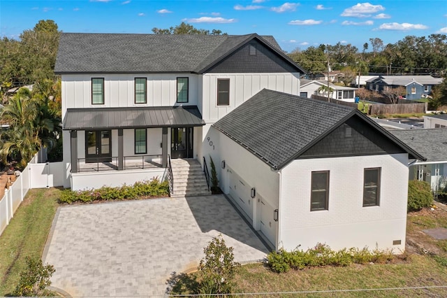 back of property featuring a porch and a garage