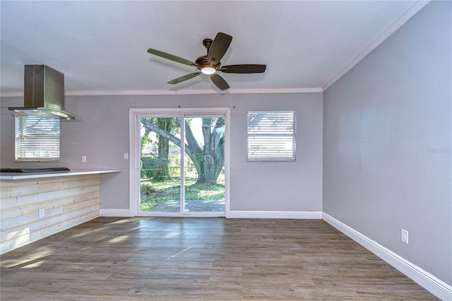 unfurnished living room with hardwood / wood-style flooring, ceiling fan, and crown molding