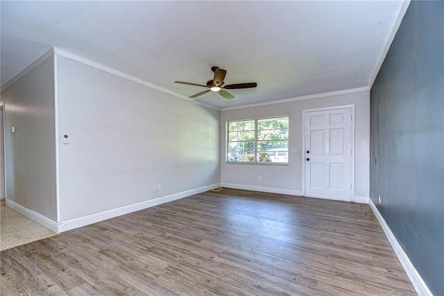 unfurnished room with ornamental molding, light wood-type flooring, and ceiling fan