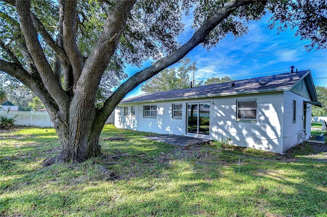 rear view of house with a lawn and a patio area