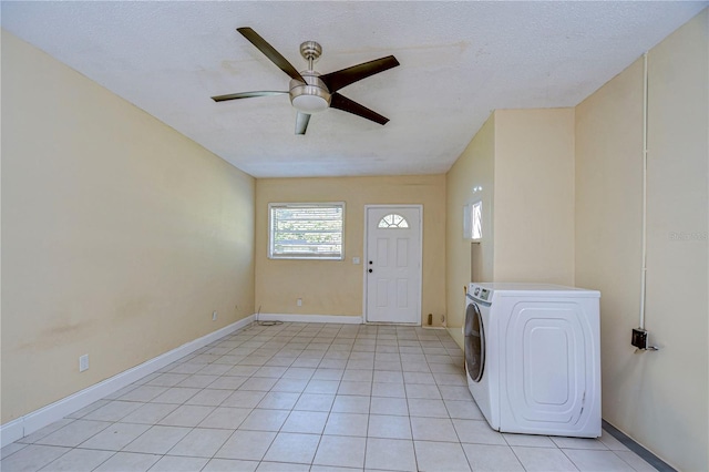 laundry room with ceiling fan, a textured ceiling, light tile patterned floors, and washer / clothes dryer