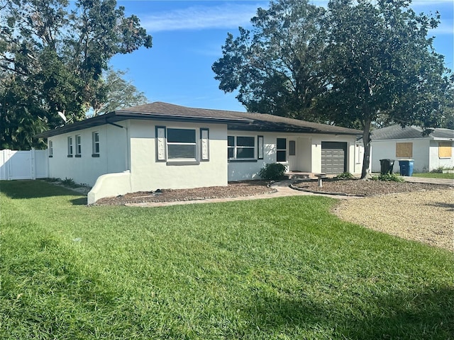 ranch-style home with a garage and a front lawn