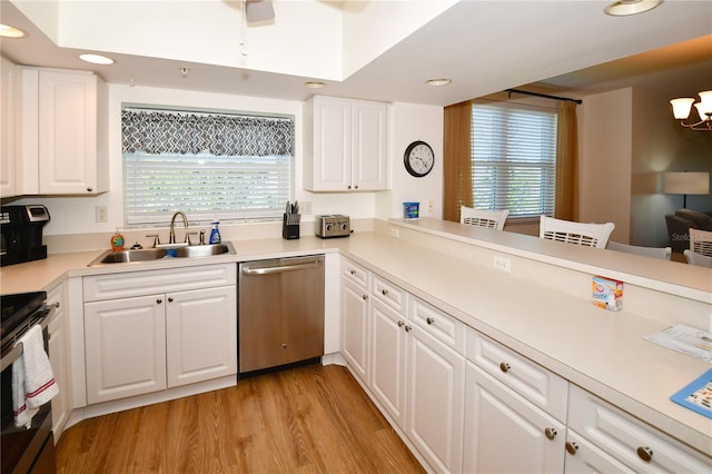 kitchen featuring a wealth of natural light, sink, white cabinetry, and stainless steel appliances