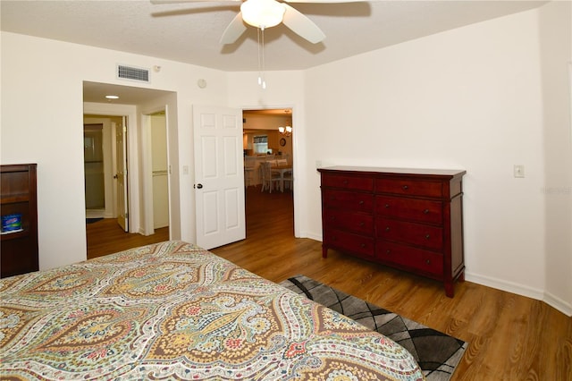 bedroom with light hardwood / wood-style flooring and ceiling fan