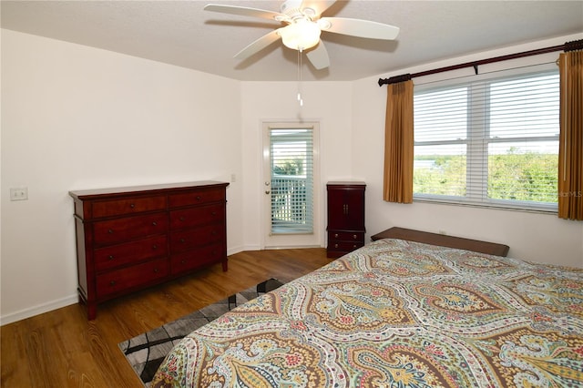 bedroom with dark hardwood / wood-style flooring and ceiling fan