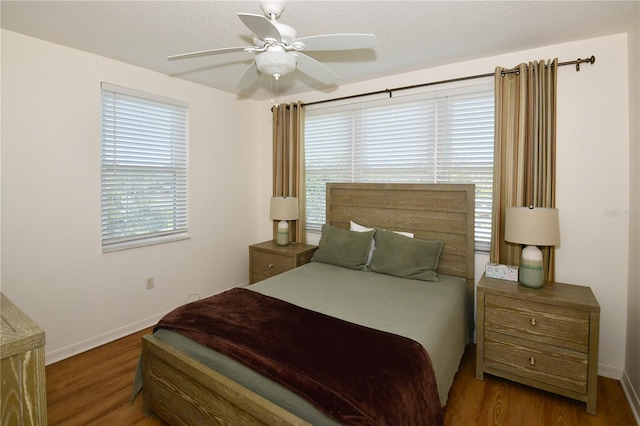 bedroom featuring dark wood-type flooring and ceiling fan