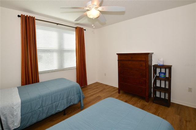 bedroom with ceiling fan and dark hardwood / wood-style floors