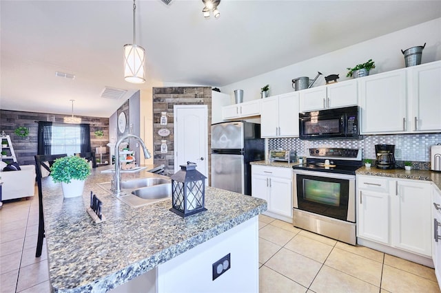 kitchen featuring hanging light fixtures, white cabinetry, a kitchen island with sink, sink, and stainless steel appliances