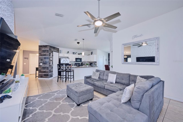 tiled living room featuring ceiling fan