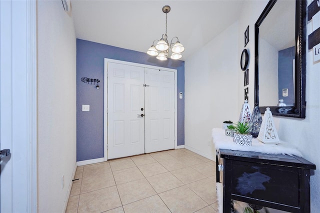 tiled foyer with a notable chandelier