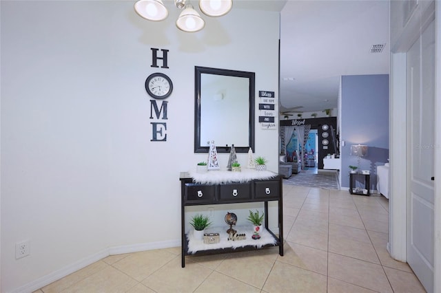 hall featuring light tile patterned floors