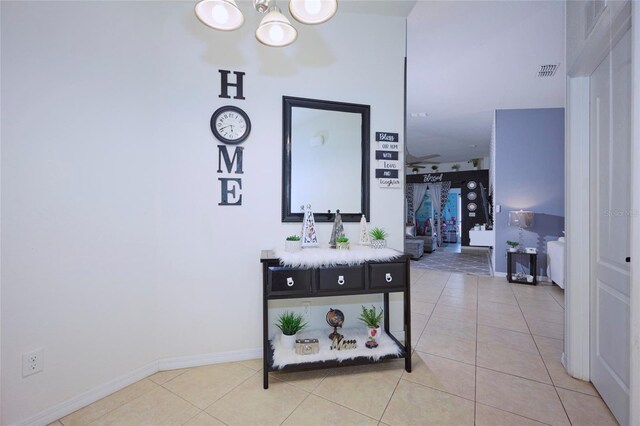 612 Chicago Way, Dundee, FL 33838 - hall with a chandelier, tile patterned flooring, and baseboards