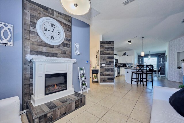 612 Chicago Way, Dundee, FL 33838 - living room featuring a glass covered fireplace, light tile patterned floors, and baseboards