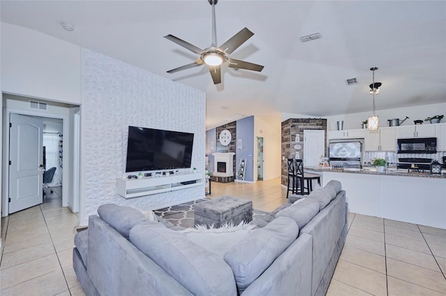 612 Chicago Way, Dundee, FL 33838 - living room with light tile patterned flooring, ceiling fan, and vaulted ceiling