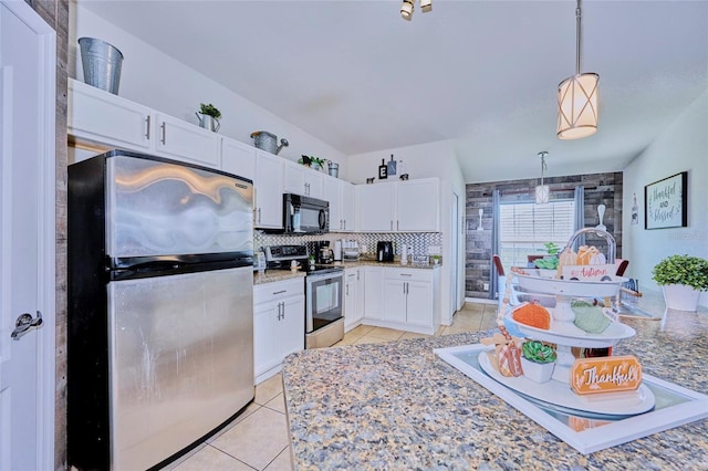 612 Chicago Way, Dundee, FL 33838 - kitchen featuring stainless steel appliances, light tile patterned flooring, white cabinets, hanging light fixtures, and backsplash