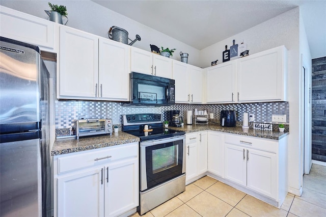 kitchen featuring decorative backsplash, appliances with stainless steel finishes, white cabinetry, and light tile patterned floors