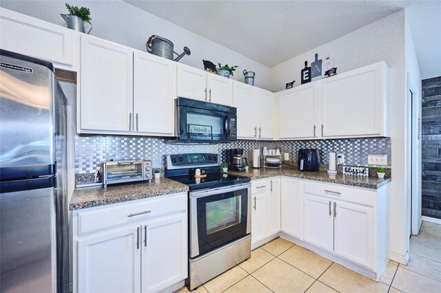 612 Chicago Way, Dundee, FL 33838 - kitchen with appliances with stainless steel finishes, white cabinetry, tasteful backsplash, and light tile patterned flooring