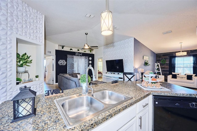 kitchen with black dishwasher, sink, vaulted ceiling, decorative light fixtures, and white cabinets