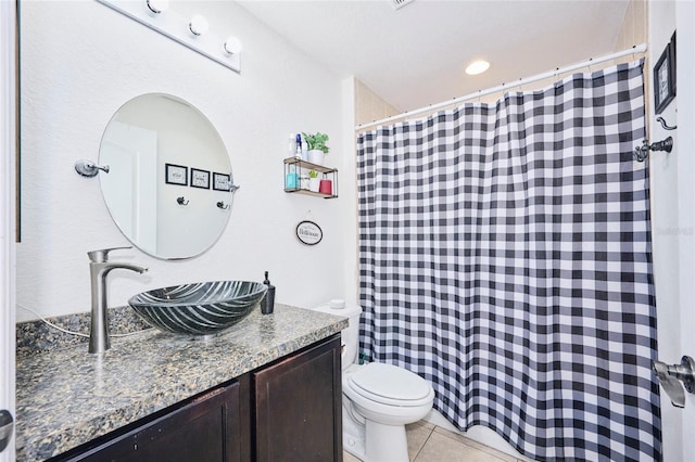 bathroom featuring vanity, toilet, tile patterned floors, and a shower with shower curtain