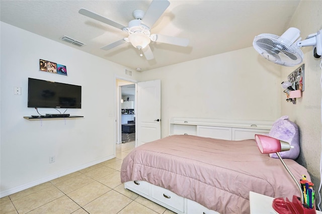 tiled bedroom featuring ceiling fan