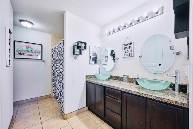 bathroom with vanity, tile patterned floors, a textured ceiling, and curtained shower