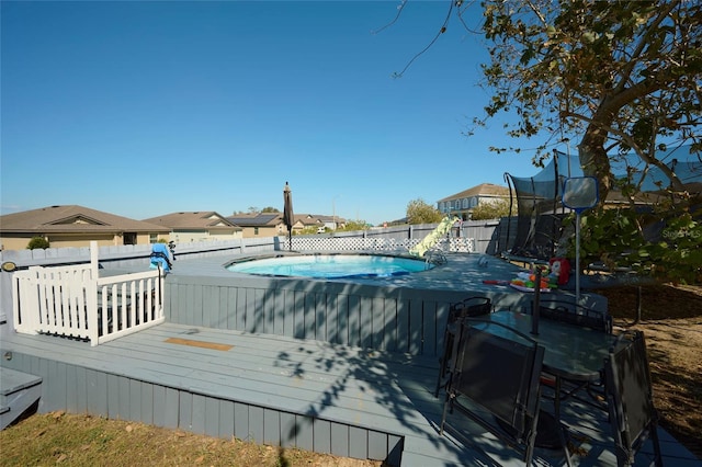 view of swimming pool with a deck