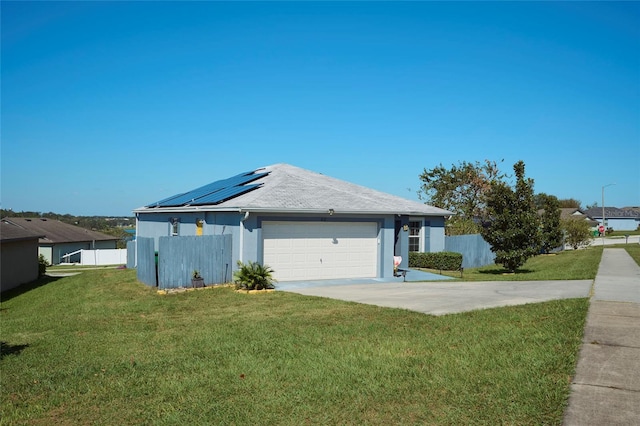 612 Chicago Way, Dundee, FL 33838 - view of front of home featuring solar panels, concrete driveway, stucco siding, and a garage