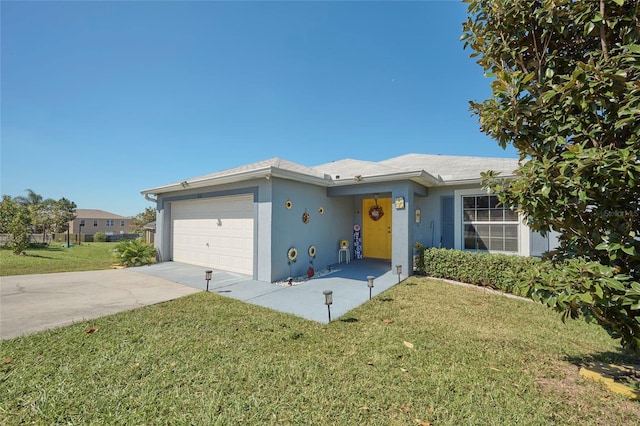 ranch-style home featuring a garage and a front lawn