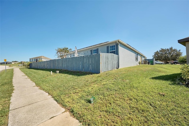 view of property exterior featuring a yard and central air condition unit