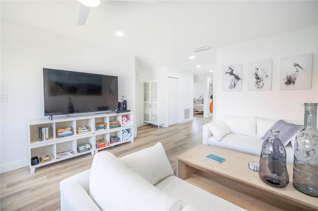 living room featuring light hardwood / wood-style floors and ceiling fan