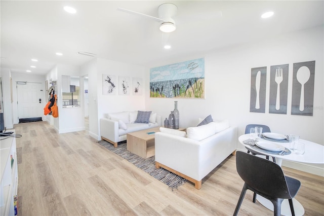 living room featuring ceiling fan and light wood-type flooring