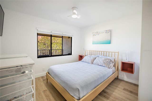 bedroom with hardwood / wood-style floors and ceiling fan