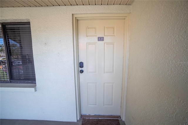 1515 Pinellas Bayway S Unit B28, Tierra Verde, FL 33715 - doorway to property featuring stucco siding
