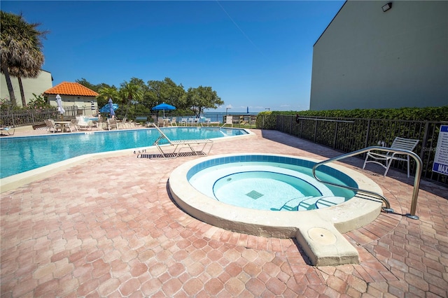 view of pool with a hot tub, a gazebo, and a patio