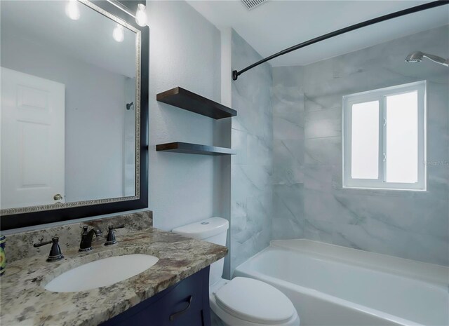 full bathroom with vanity, toilet, and tiled shower / bath combo