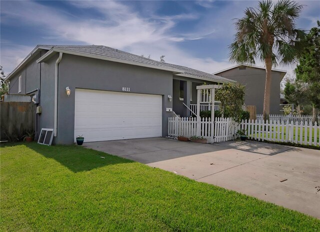 single story home featuring a front yard and a garage