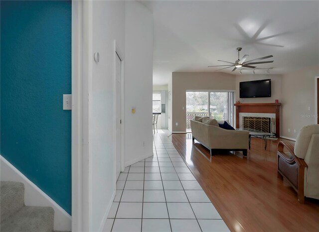 interior space with ceiling fan and light hardwood / wood-style flooring