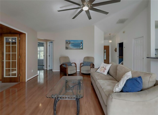 living room featuring ceiling fan, wood-type flooring, and lofted ceiling